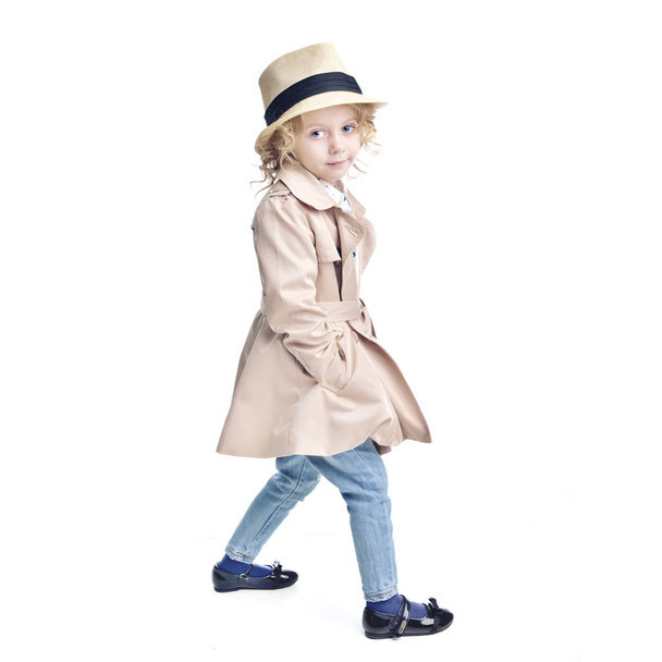 Fashionable child. Blonde girl in a stylish raincoat and hat. - Fotó, kép