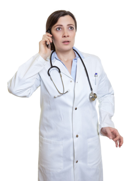 Caucasian female doctor gets an emergency call - Foto, Imagen
