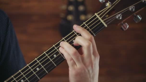 close up mans hand taking chords on acoustic guitar slow motion - Footage, Video