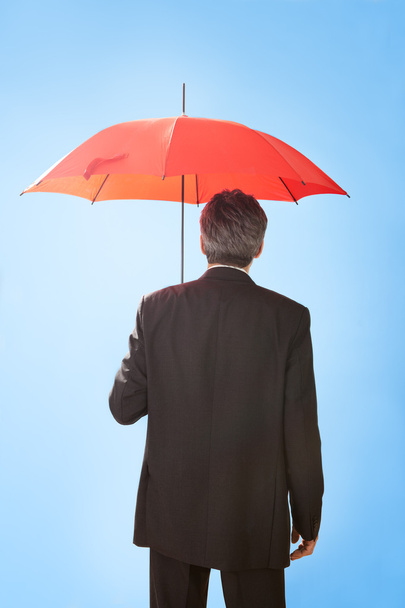 Senior businessmen holding a umbrella - Фото, зображення