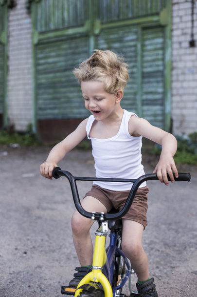 Child on a bicycle at asphalt road. Childhood. Sport. Cycling - Valokuva, kuva