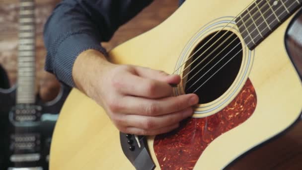 close up man playing the guitar with mediator - Felvétel, videó