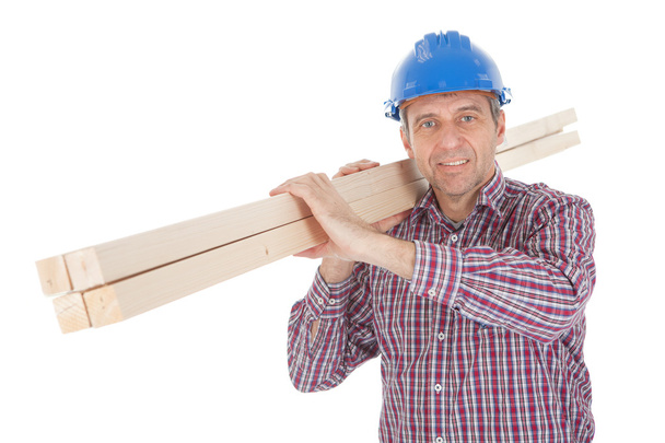 Builder carrying timber - Photo, Image