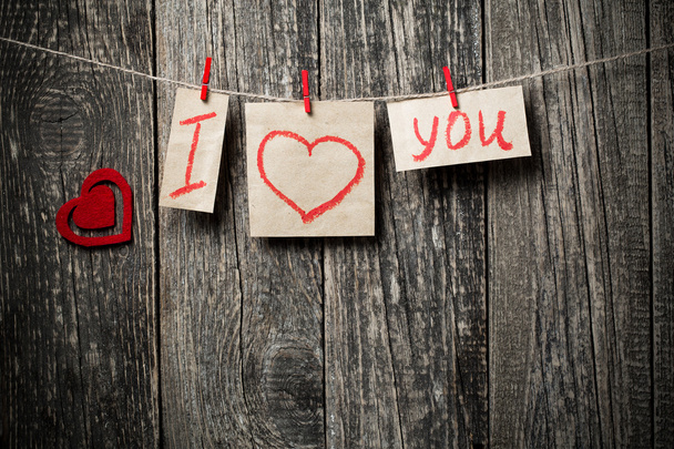 Handwritten words I love you and hearts on wooden background. - Foto, afbeelding