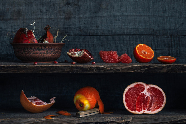 Citrus and pomegranate on the shelves, rustic style - Photo, Image