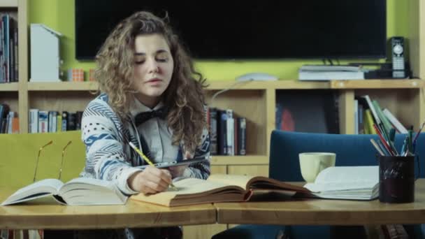 female student reading books and using a tablet slow motion - Footage, Video