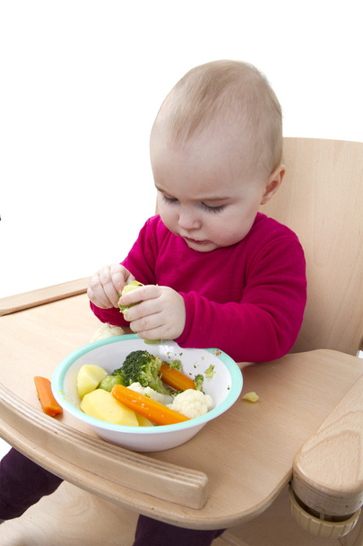 Criança comendo em cadeira alta
 - Foto, Imagem