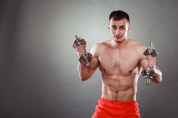 man exercising with dumbbells. - Foto, afbeelding