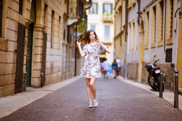 lady walking down the ancient street - Zdjęcie, obraz