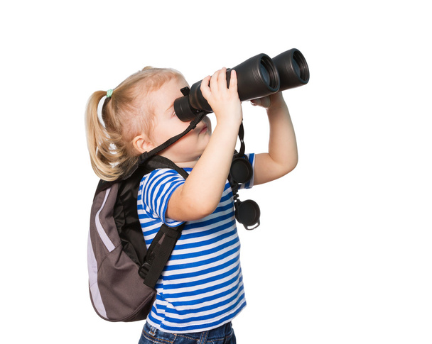 Little Funny girl looking through binoculars. - Foto, afbeelding