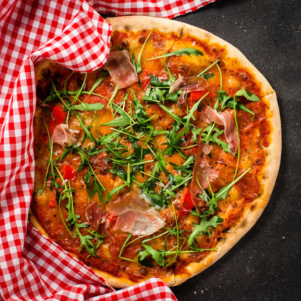 Italian pizza on dark table - Foto, imagen