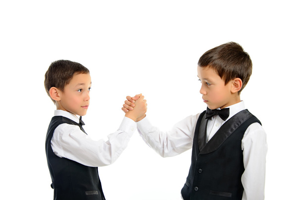 Twins playing arm wrestling isolated - Foto, imagen