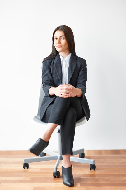 young businesswoman sitting on chair - Fotó, kép