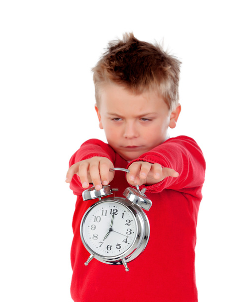 Vihainen pikkupoika pitelee kelloa
   - Valokuva, kuva