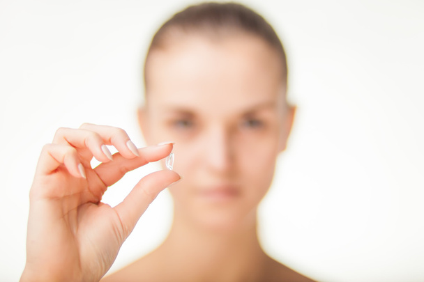 Woman with contact lens on finger healthcare concept - Foto, Bild