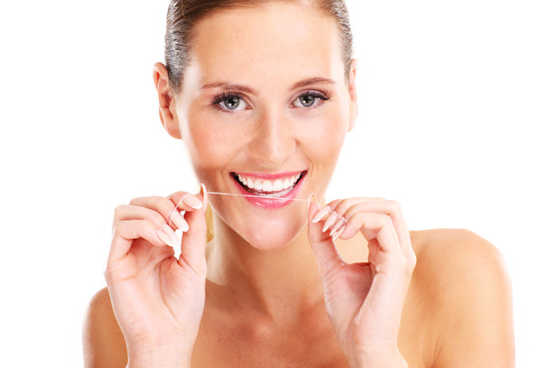 Woman using dental floss - Foto, imagen