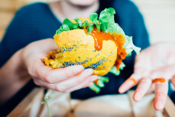 holding a vegan burger  - Fotó, kép