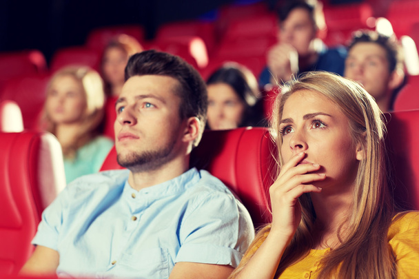 happy friends watching horror movie in theater - Photo, image