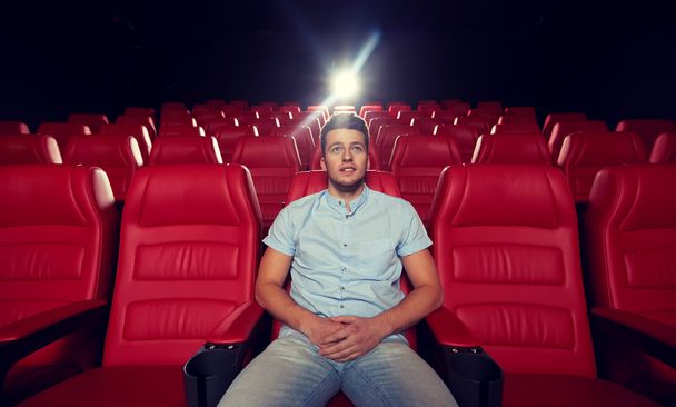 happy young man watching movie in theater - Φωτογραφία, εικόνα