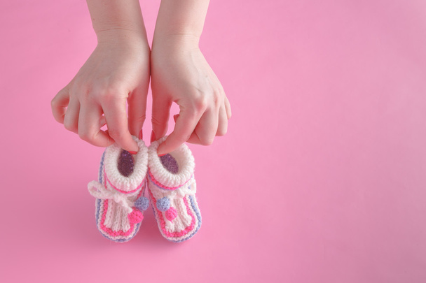 Female hold tiny newborn booties - Foto, Imagem