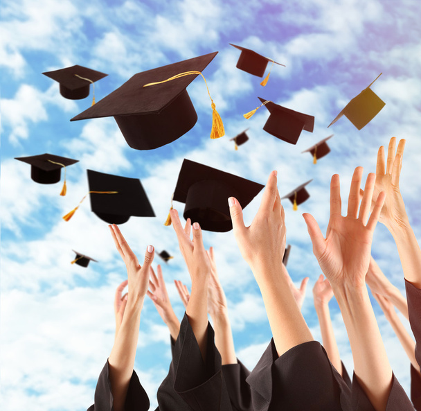 Graduates hands throwing graduation hats - Fotografie, Obrázek
