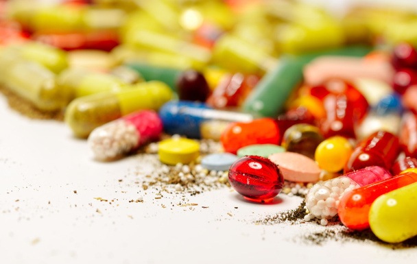 various colorful pills against white background - Fotó, kép