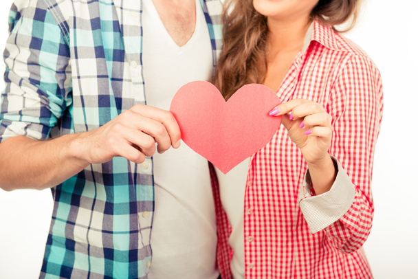 Lovely couple in love holding paper heart - Foto, afbeelding