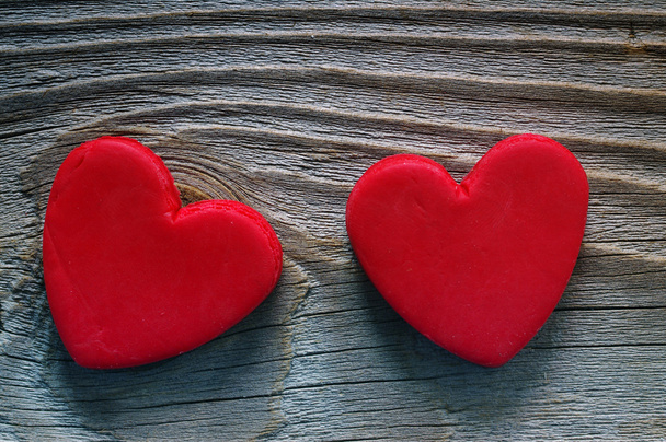 Two red heart  on a wooden old background. Romantic card. - Photo, Image
