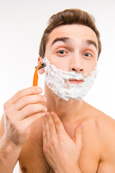 Handsome funny man with shaving foam on his face and razor - Φωτογραφία, εικόνα