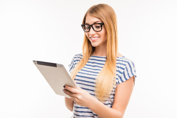 Girl in glasses with tablet reading news - Foto, afbeelding