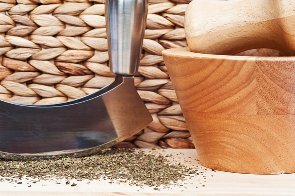 Chopped tarragon with herb chopped and wooden utensils - Zdjęcie, obraz
