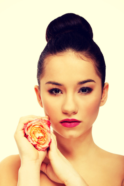 Beautiful woman with pink rose. - Φωτογραφία, εικόνα