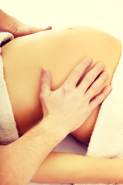 Pregnant woman having a relaxing massage - Фото, изображение