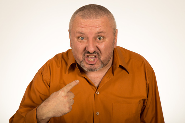 Closeup portrait of angry, mad, unhappy man pointing at himself asking you mean me, you talking to me, isolated on white background - Photo, Image