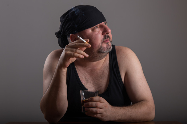 Adult man is smoking cigarette and drinking whiskey - Photo, Image