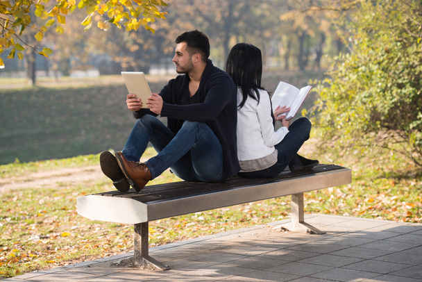 Couple Enjoying Book And Digtial Tablet Touchpad - Fotó, kép