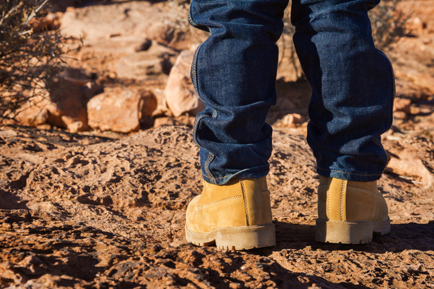 Garçon en chaussures jaunes debout dans le désert
 - Photo, image