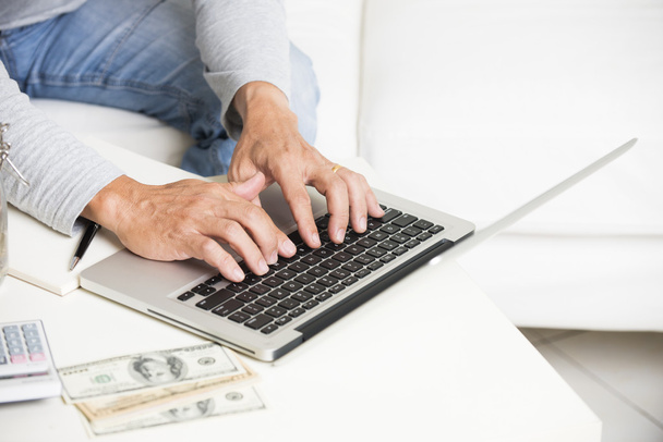 Man doing finance with laptop - Foto, afbeelding