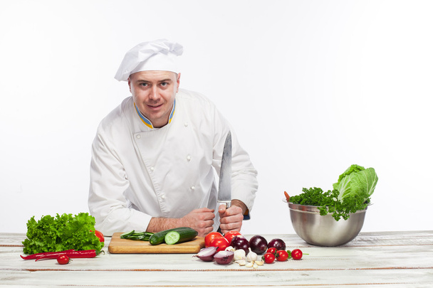 Chef posing with knife in his kitchen - Foto, Imagen