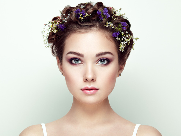 Face of beautiful woman decorated with flowers - Фото, изображение