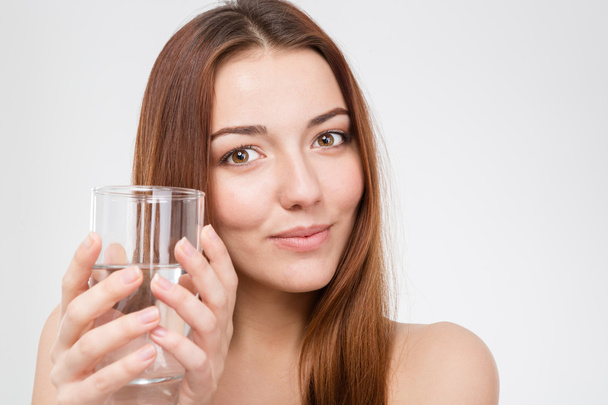 Pretty smiling young woman with glass of water - Zdjęcie, obraz