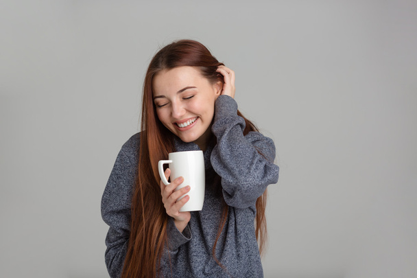 Cheerful lovely woman with long hair drinking coffee and smiling  - Φωτογραφία, εικόνα