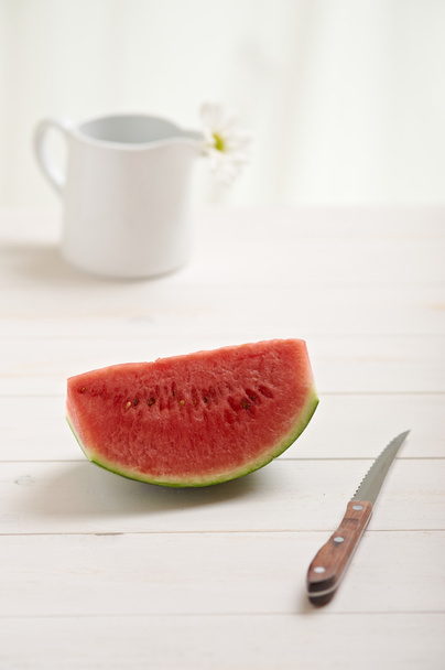 Watermelon on a white wood table - Foto, imagen