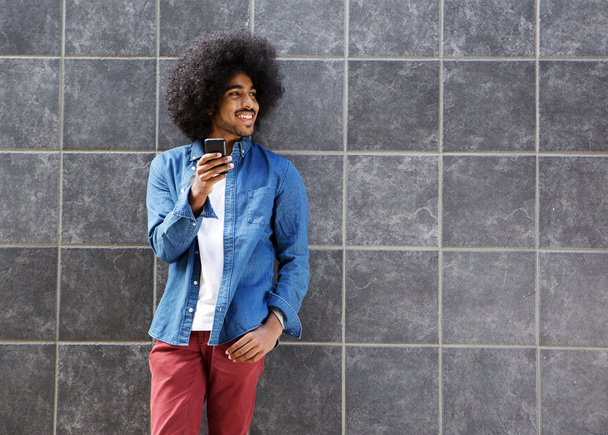 Cool guy with afro using cellphone - Photo, Image