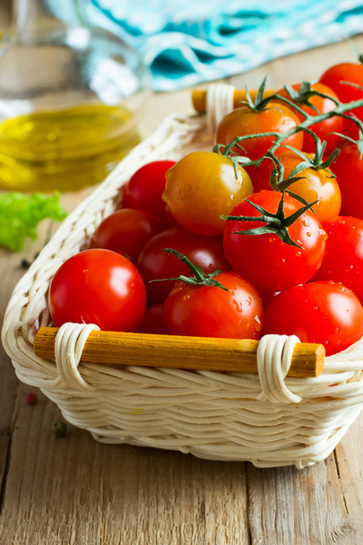 Fresh cherry tomatoes on wooden table. Ingredients for tomato sauce - Фото, зображення