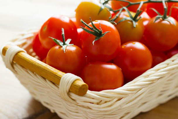 Fresh cherry tomatoes on wooden table. Ingredients for tomato sauce - Foto, Imagen