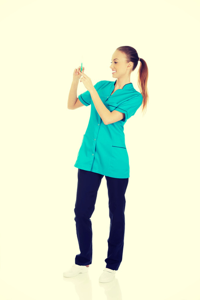 Nurse with a syringe in hand. - Fotoğraf, Görsel