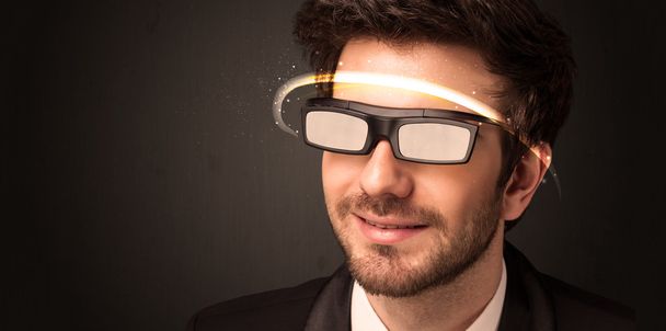 Handsome man looking with futuristic high tech glasses  - Fotó, kép