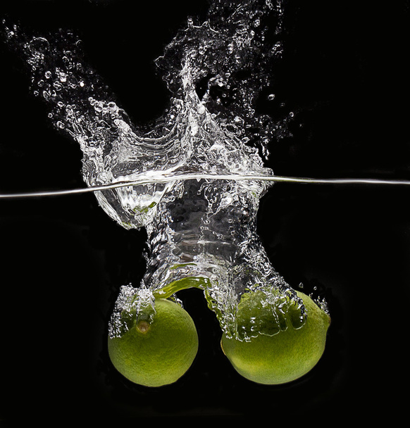 Lime splash on a black background - Foto, Imagen