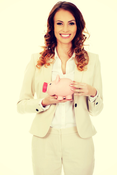 Business woman with a piggybank. - Fotografie, Obrázek